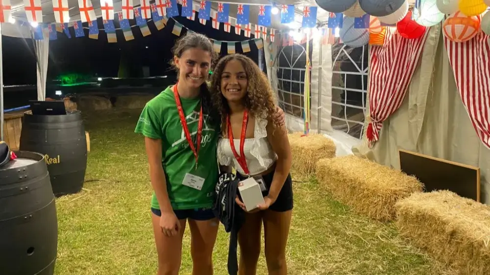 Young participant receiving an award from their international coach at the camp the Village.