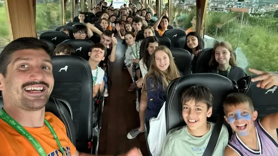 Young participants from The Village English summer camp on the bus heading to an excursion.