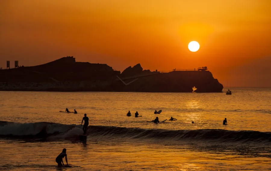 Sunset at Salinas beach where surfing takes place at the Village