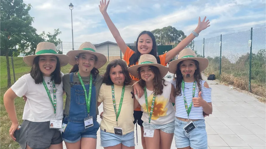 Five girls with their international coach at the hotel entrance - the Village
