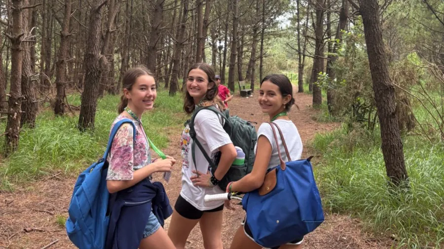 Three girls hiking in a forest - the Village