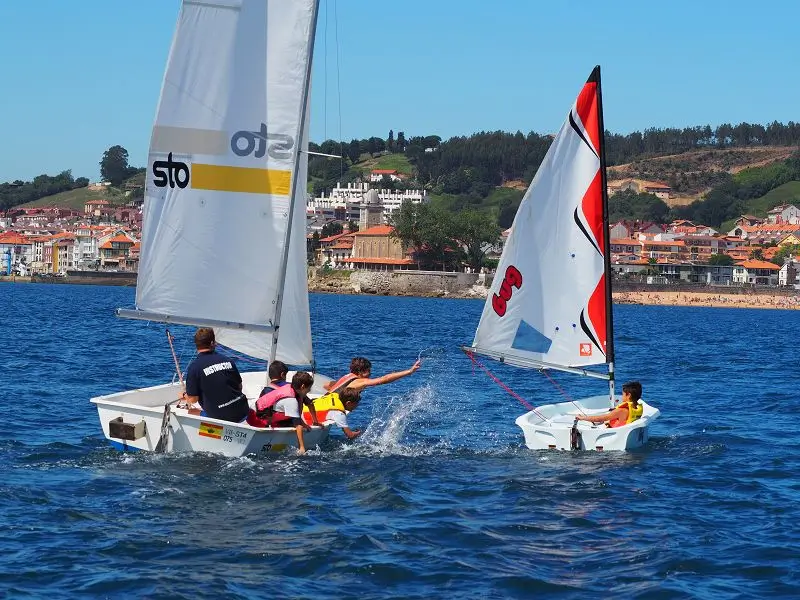 Zwei Boote mit Teilnehmern des Englisch Sommercamp in Spanien während der Segelaktivität in der Bucht von Luanco