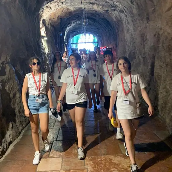 Young people in a cave during an excursion day at the summer camp