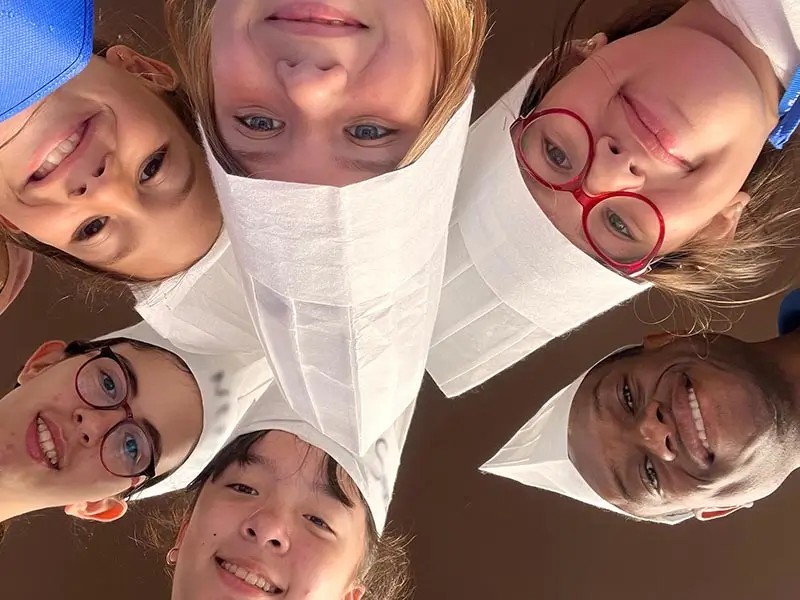 A group of kids posing during the cooking activity at the international summer camp in Spain