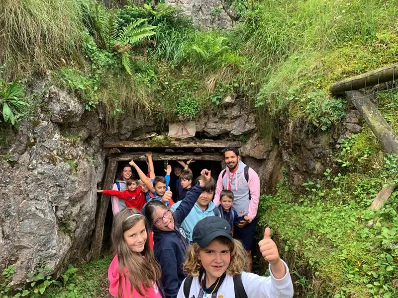 A group of kids waving during a mountain excursion at the international summer camp in Spain the Village