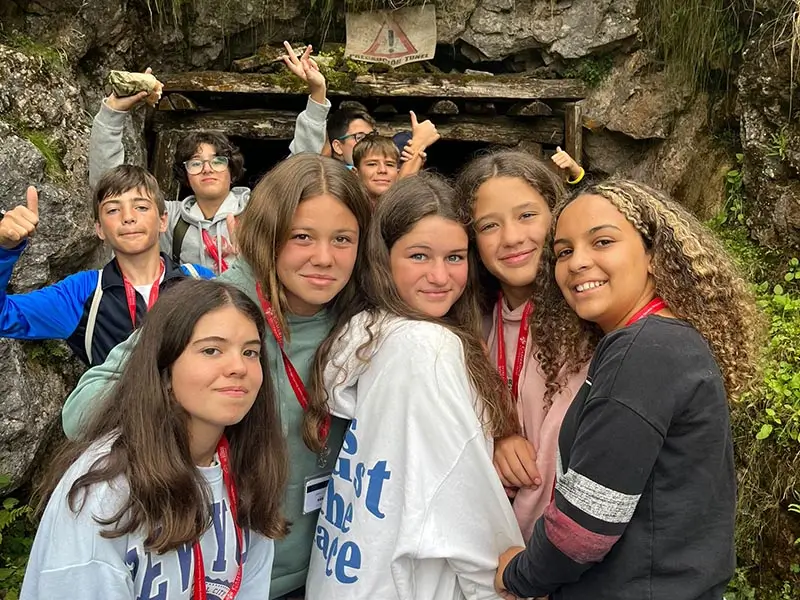 Group of teenagers posing during a mountain excursion organized by the summer camp in Spain for teens