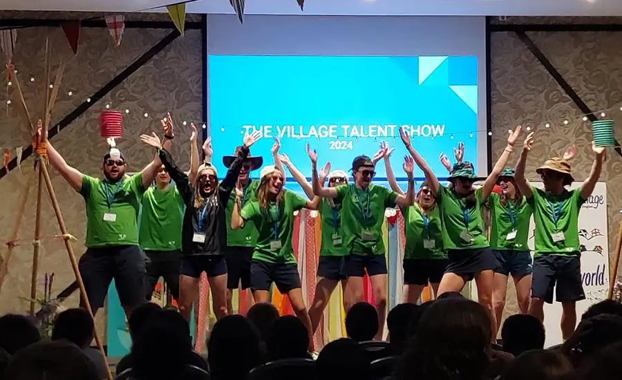 A group of coaches at the English summer camp during a Talent Show performance in the Village